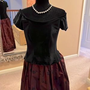 Black Velveteen off the shoulder top with zipper back and cap sleeve.